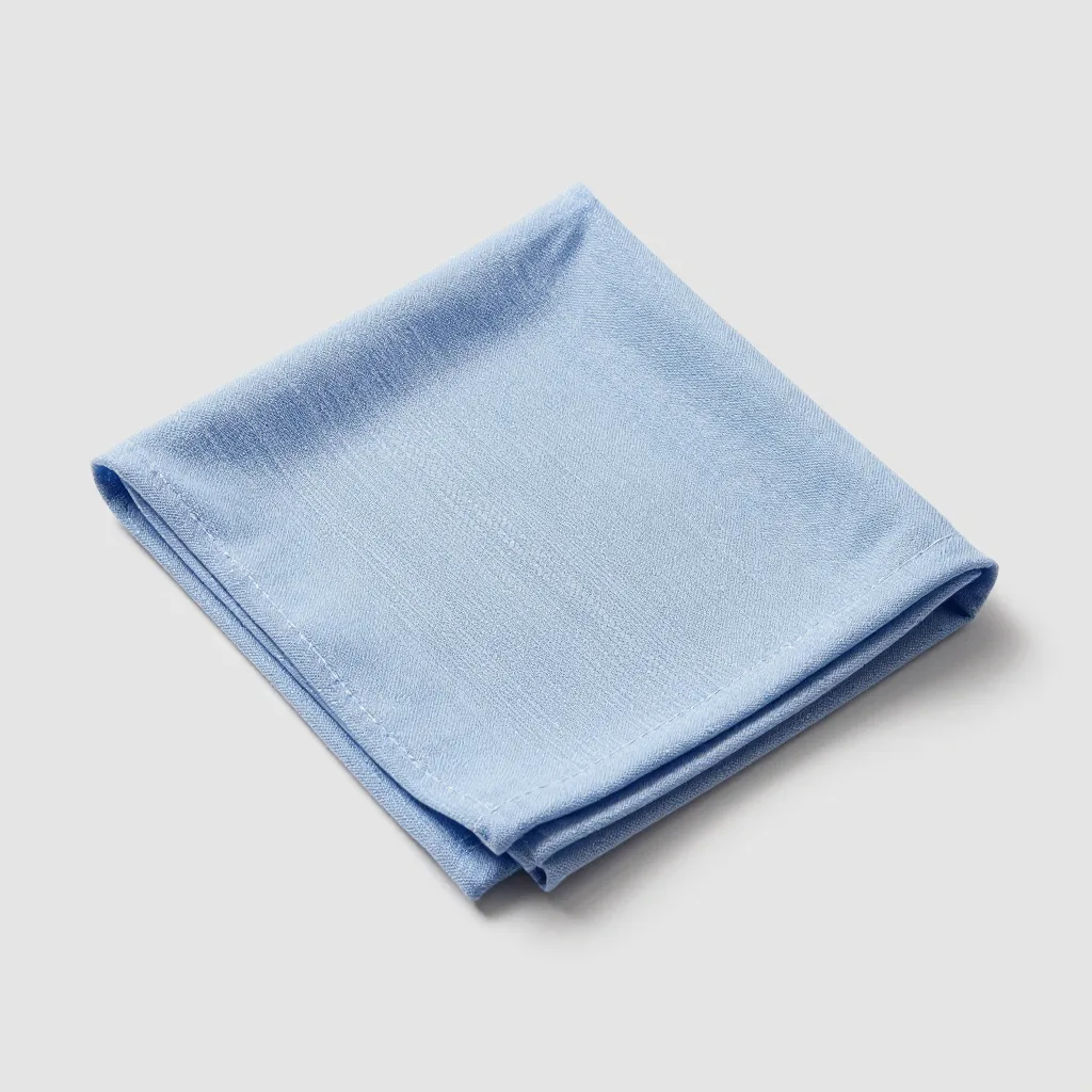 A single Swedish dishcloth in blue on a light background