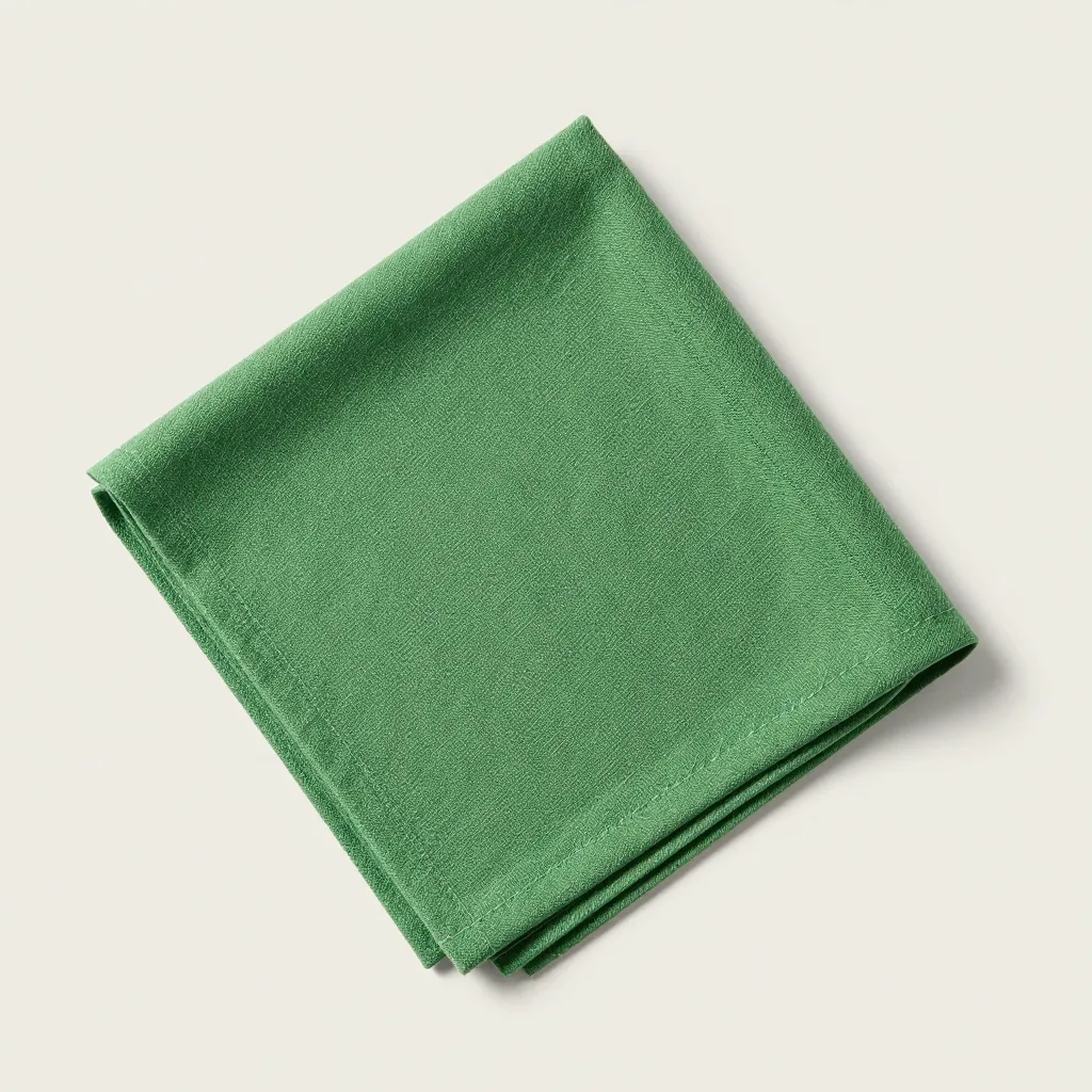 A single Swedish dishcloth in green on a light background